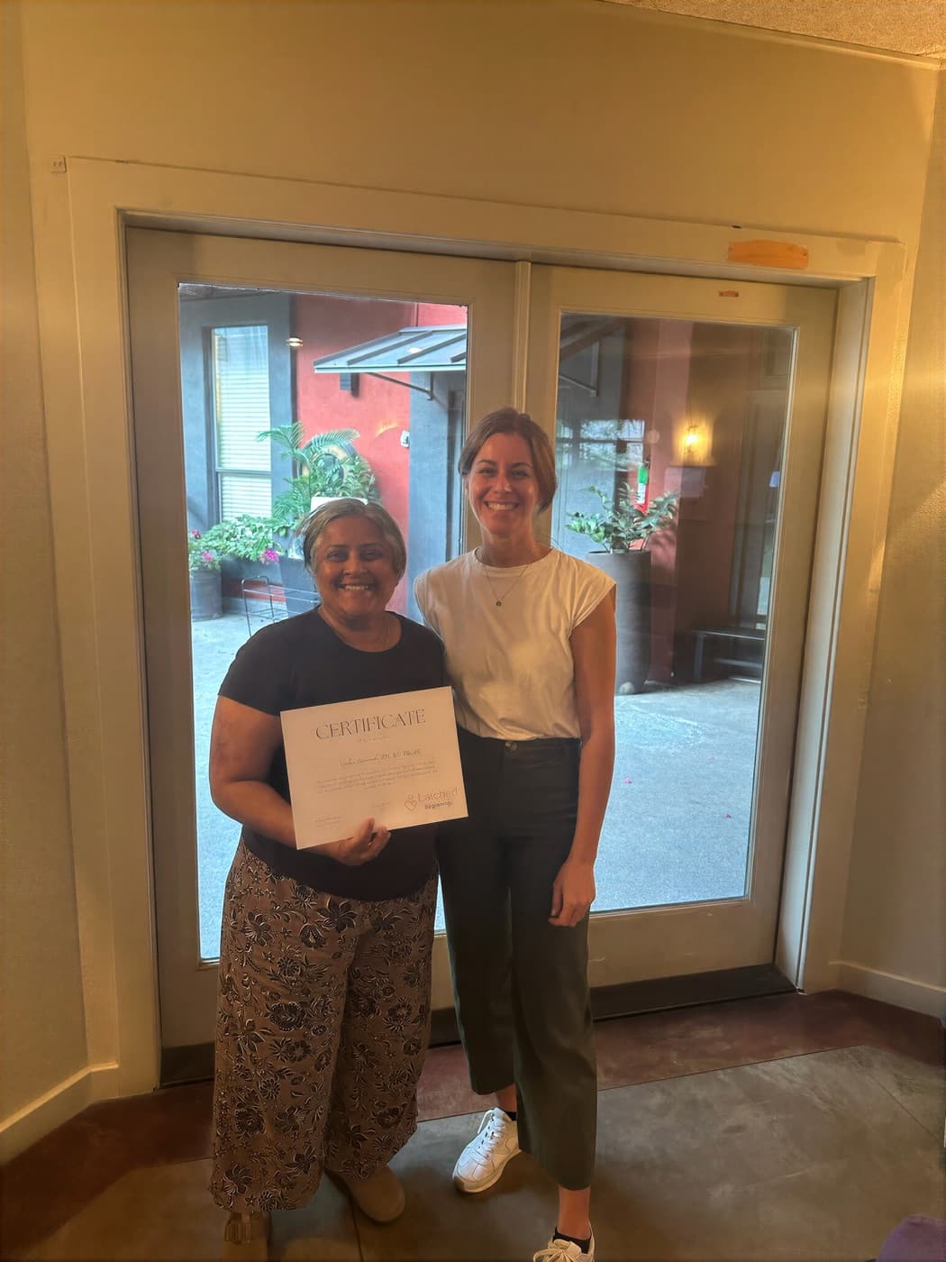 Dr. Kacie Culotta presenting a Latched Beginnings certificate to a provider she mentored